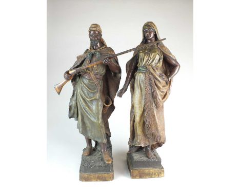 A pair of large Goldscheider figures circa 1895 depicting Antar, Son of Cheddad and Abla, Bride of Antar, cold-painted terrac