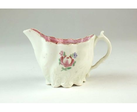 A Caughley 'Low Chelsea' cream ewercirca 1780-90the lobed body moulded with spiralling foliage, painted in polychrome with a 