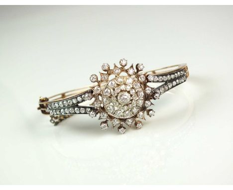 A late 19th century diamond bangle/pendant, designed as a central circular cluster of graduated old cut diamonds mounted with