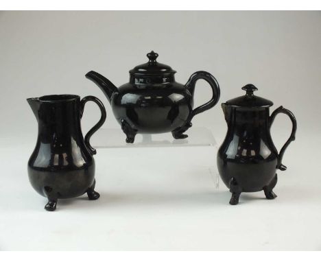 A small group of Jackfield black-glazed earthenwarecirca 1750-60each raised on three paw feet, comprising a teapot and cover,