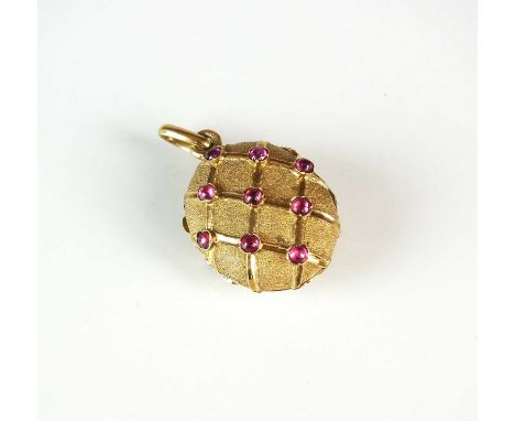 A cabochon ruby locket, designed as an oval locket mounted with eighteen round cabochon rubies, the lug indistinctly stamped,