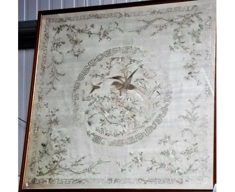 Chinese silk embroidered panel decorated with a central circular reserve of a bird on a foliate branch within a key border, h
