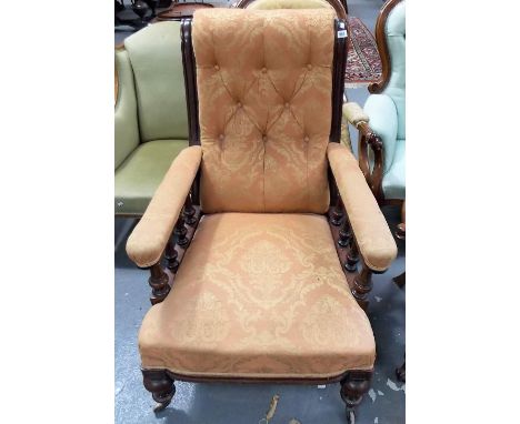 Victorian walnut framed and button back upholstered gentleman's salon chair with turned and fluted forelegs and with brass ca