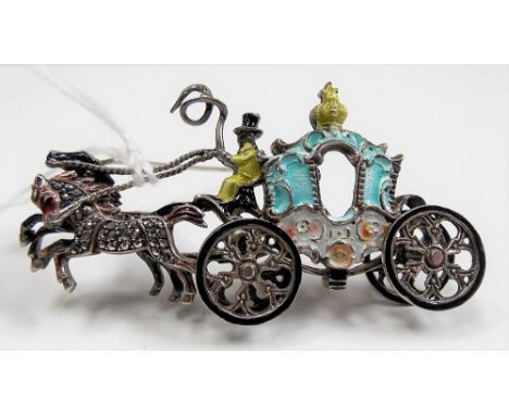 A novelty white metal enamel and marcasite set brooch modelled as a horse and carriage and with working wheels, length 7cm, w