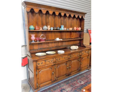 Good reproduction George III-style oak dresser, the top with a moulded cornice over a shaped apron and with two fixed shelves