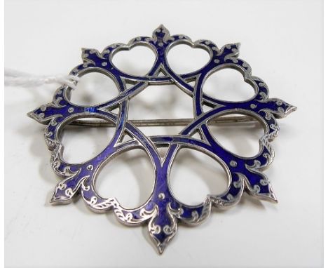 A white metal and blue enamel circular pierced scroll blue enamel brooch, stamped SILVER diameter 6cm, weight 16g approx