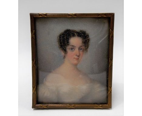 Early 19th Century rectangular half length portrait miniature on ivory of a young woman in white dress, within brass frame, 8