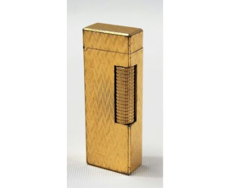 Gold plated Dunhill engine turned patented lighter of rectangular form.