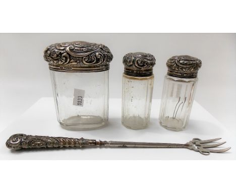 Victorian silver lidded toilet bottles by Drew & Sons, London 1899; together with a silver embossed weighted handle pickle fo