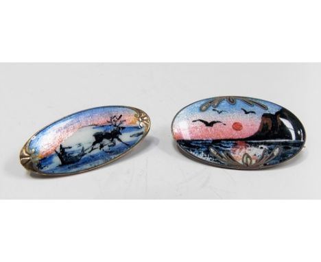 Two Scandinavian 925 silver and enamel oval brooches, one depicting a reindeer and sled, the other a seascape, width of large