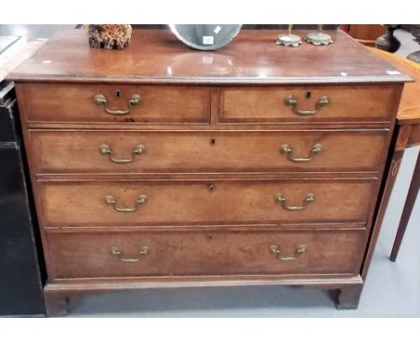George III oak mahogany cross banded straight front chest of two short over three long graduated drawers upon bracket feet, w