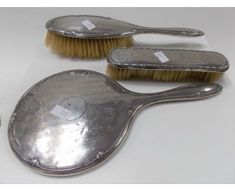 George V silver engine turned and embossed hairbrush and hand mirror, Birmingham 1922 together with a clothes brush (3).