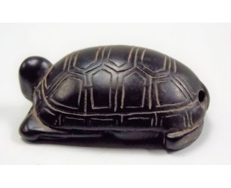 Japanese carved wood Netsuke modelled as a tortoise on one side, the other a jovial sage, signed, length 4.5cm.