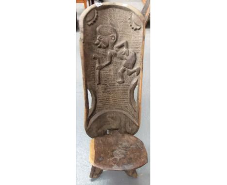 African two section carved hardwood chair, the back carved in relief with a bent figure with stick, height 91cm.