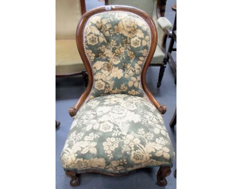 Victorian walnut framed button back upholstered salon chair with squat cabriole legs.
