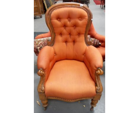 Victorian walnut framed button back armchair with scroll carved arm supports and on turned forelegs with ceramic castors.