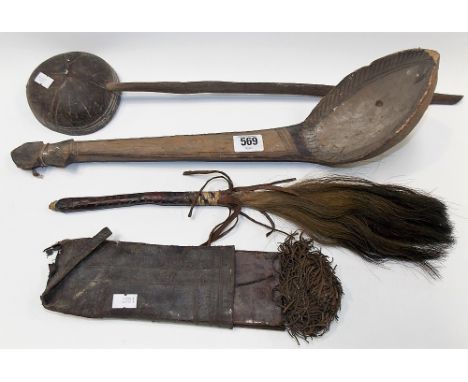 A Ceylon coconut shell and palm wood spoon, length 52cm together with another ethnic carved wood spoon with engraved decorati