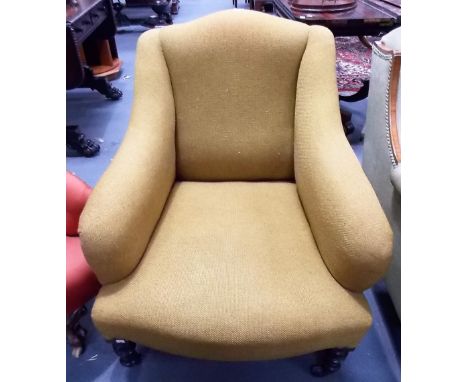 Edwardian upholstered armchair with ring turned baluster legs and ceramic castors. 
