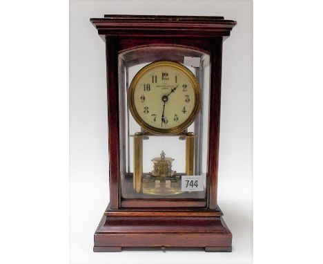 Early 20th Century lacquered brass torsion timepiece by Benet Frink & Co Ltd within mahogany four glass case and with 3.5in c