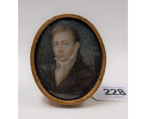 Early 19th Century British portrait miniature on ivory, quarter length wearing brown coat, oval, 6.5cm x 5cm, within brass fr