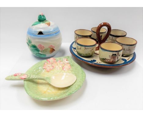 Clarice Cliff relief moulded ovoid preserve pot and cover together with a Clarice Cliff leaf moulded dish and spoon and a Wat