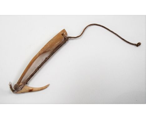 Rare oceanic mother of pearl and bone fish hook with fibre bindings, length 9.5cm.