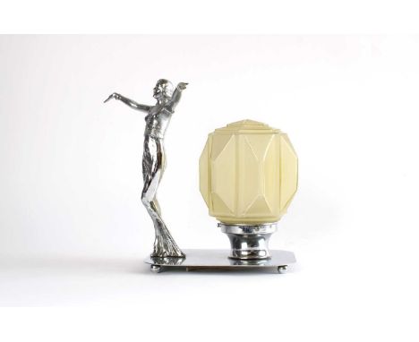 Art Deco Chromed Table Lamp Circa 1930, mounted with a female dancer and moulded opaque glass shade, raised on shaped oval ba
