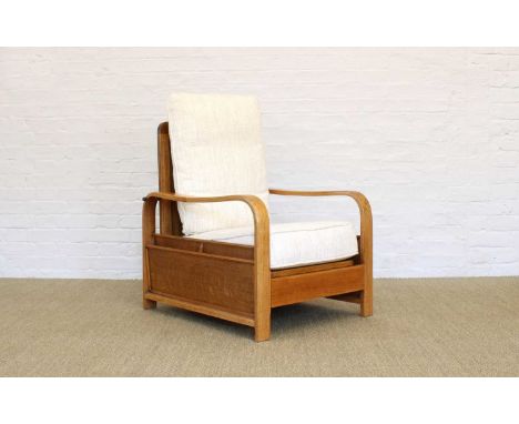 Heal's of London Art Deco Oak Reading Chair Circa 1930, featuring magazine racks to both sides and upholstered with modern cr