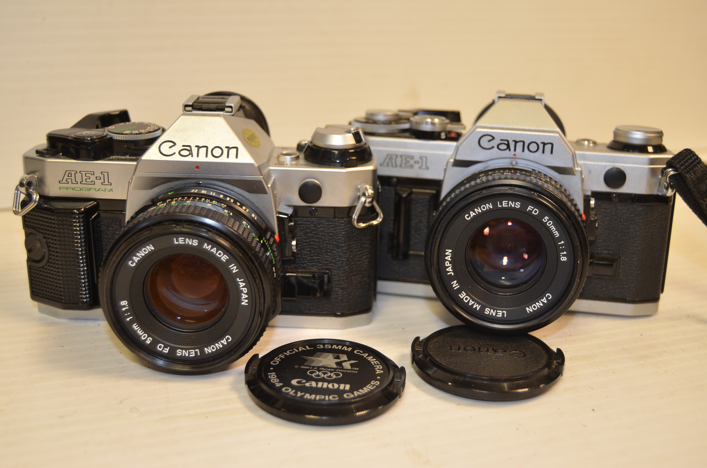 A Pair Of Canon Ae 1 Slr Cameras Chrome With 50mm F 1 8 Fd Lenses Bodies G One Example The