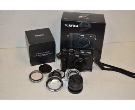 A Fuji X100T Digital Camera,  black, 16 megapixels, untested, complete with accessories including a Fujinon Wide conversion l