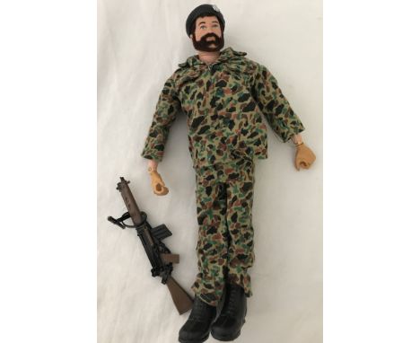 A vintage action man with beard in camouflage outfit with beret and gun  