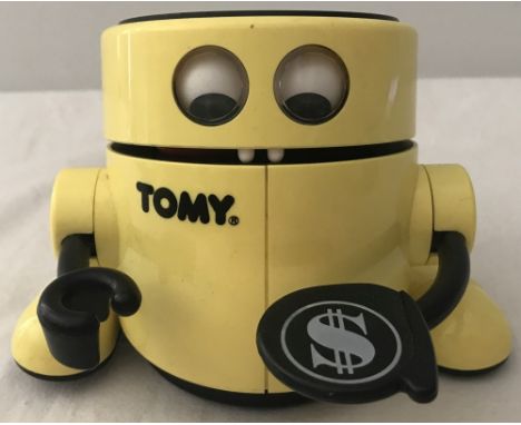 A yellow and black late 1980's "Mr. Money" automatic robot money bank by Tomy.  Total height  approx. 9.5cm.