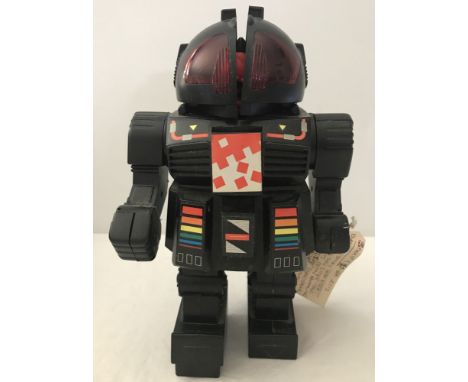 A 1980's Star-Master Jet Smoke battery operated toy robot. With Stop and walk action, helmet opens to reveal dinosaur head wh