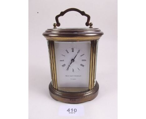 A brass cased oval carriage clock