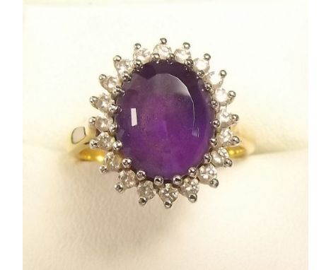 An 18 carat gold amethyst and diamond cluster ring