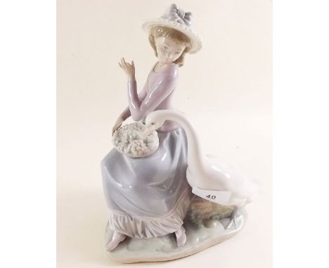 A Lladro group girl with basket of grapes and goose 