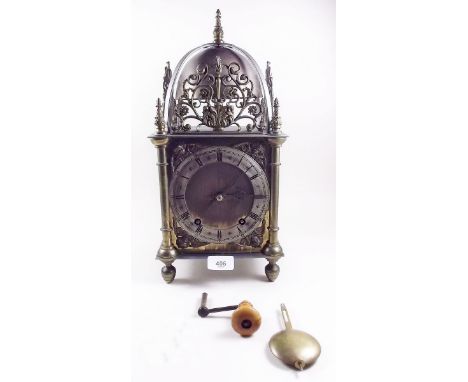 A Victorian large brass lantern clock with sun mask motif to sides, striking quarter hours, 40cm