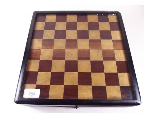 An early 20th century wooden games box with chess board top, backgammon board within and nine man morris to base