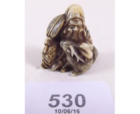 A Japanese ivory netsuke depicting man and deer 