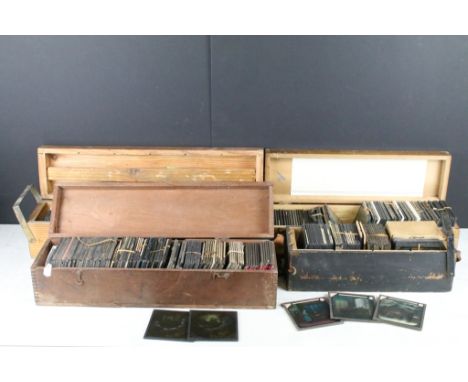 A collection of over 100 glass magic lantern slides contained within four wooden cases to include Religious, Educational, nur