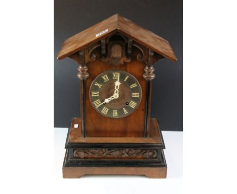 Late 19th / early 20th century Black Forest carved oak mantle cuckoo clock, the circular dial with Roman numerals, with Jungh