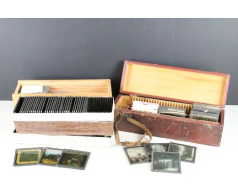 A collection of over 100 glass magic lantern slides contained within three wooden boxes, mainly religious examples including 