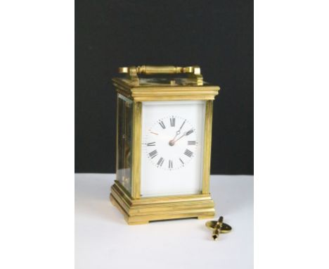 A brass cased carriage clock with bevelled glass panels, with hourly repeater button to the top. Approx 13cm tall