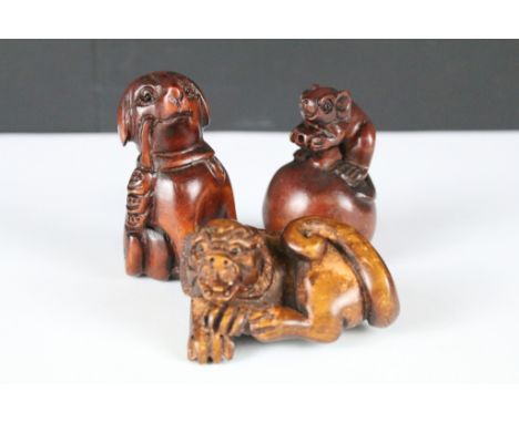 Japanese Signed Wooden Netsuke in the form of a Dog, Japanese Wooden Netsuke in the form of a Rat on an Apple and a Signed Wo