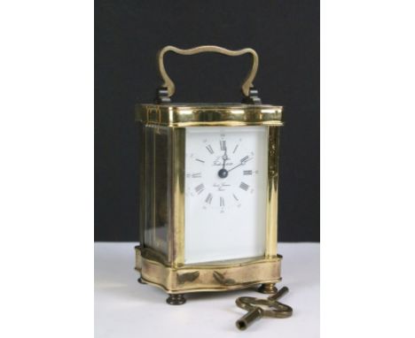 A French made gilt brass cased carriage clock with bevelled glass panels, complete with key. 