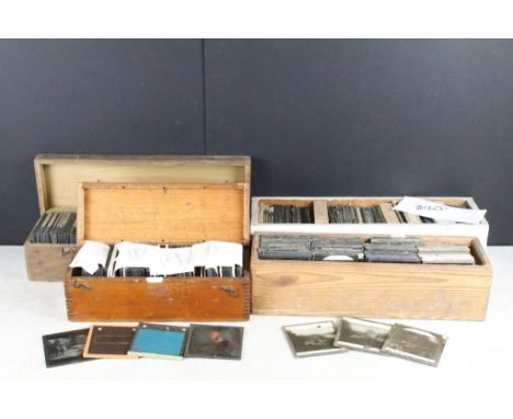 A collection of over 100 mixed glass magic lantern slides contained within four wooden cases to include religious and topogra