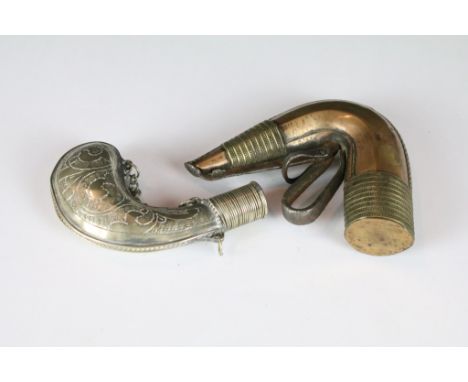An antique brass Islamic powder flask together with a white metal example. 