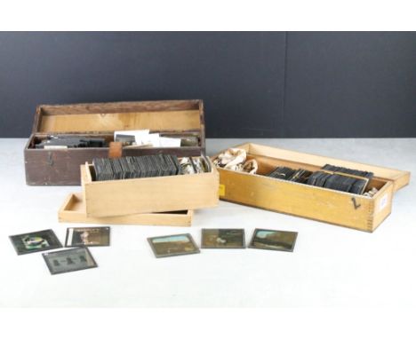 A collection of over 100 glass magic lantern slides contained within three wooden boxes to include Advertising, Street Life a