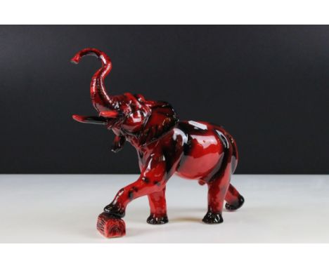 Peggy Davies flambe elephant ceramic figurine, modelled with trunk raised. Printed marks to underside. Measures approx 24cm t