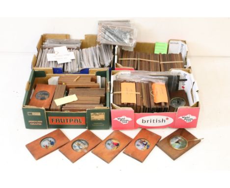 A large collection of wooden framed coloured magic lantern slides to include lever action examples, contained within four box